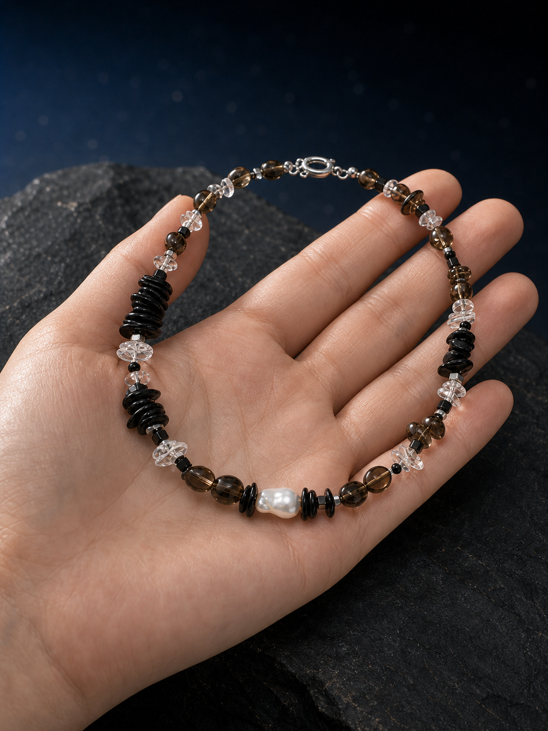 Ash Sequence Smoky Quartz Necklace shown in hand for scale