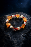 Ember Cord Citrine Pearl Bracelet front view on a dark atmospheric backdrop