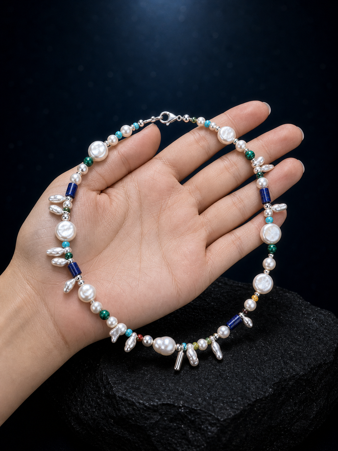 Forest Isle Silver Sequence Necklace shown in hand for scale