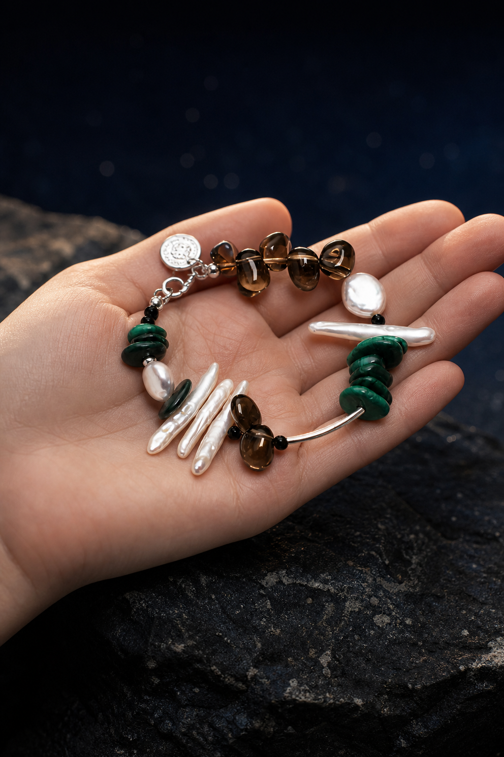 Forest Tide Malachite Pearl Bracelet shown in hand for scale