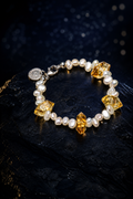 Golden Tide Citrine Pearl Bracelet front view on a dark atmospheric backdrop