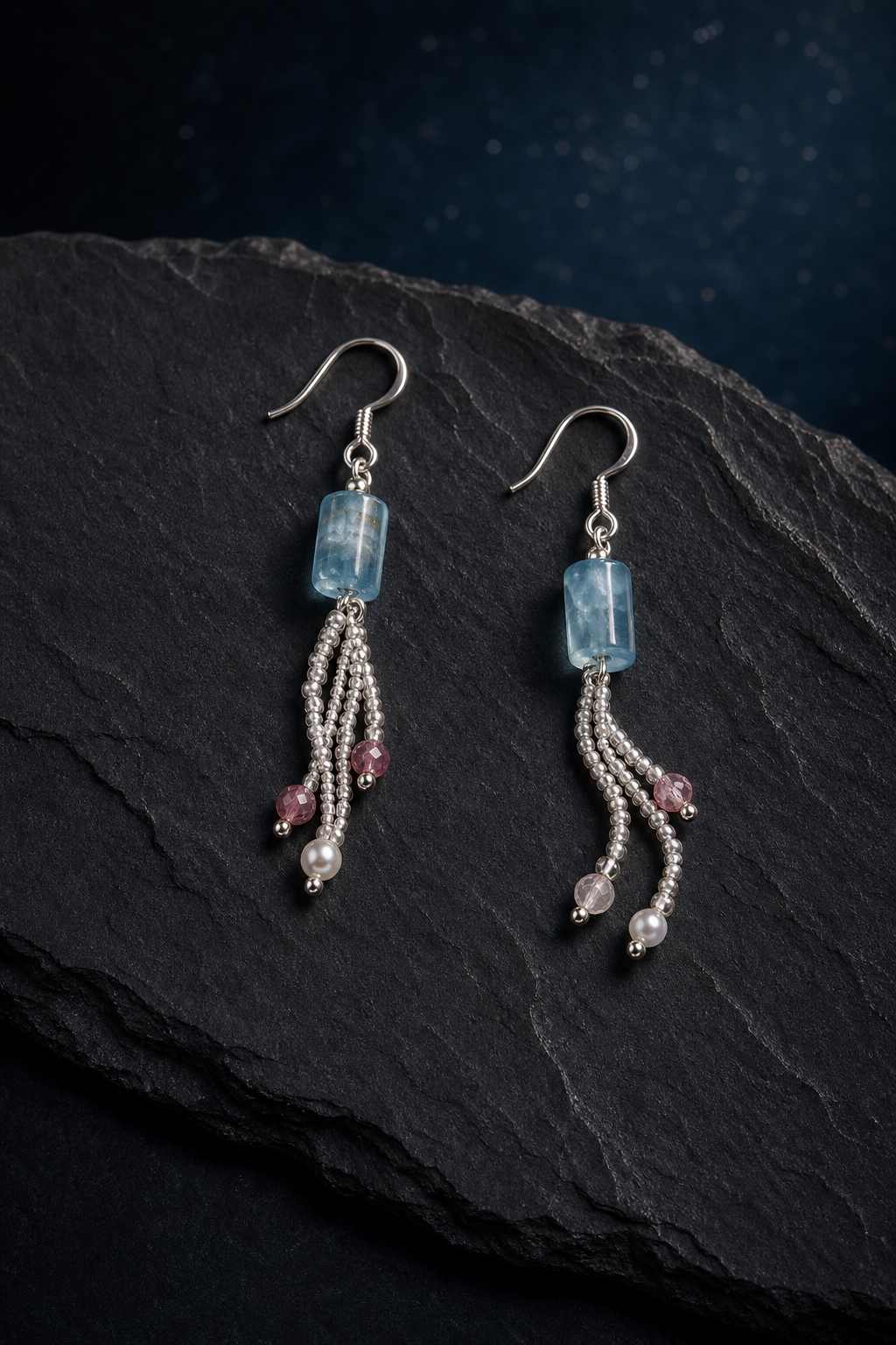 Ice Blue Tourmaline Pearl Earrings (6.1 cm) front view on a dark atmospheric backdrop