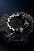 Obsidian Current Bracelet front view on a dark atmospheric backdrop