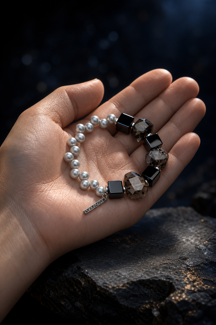 Obsidian Current Bracelet shown in hand for scale