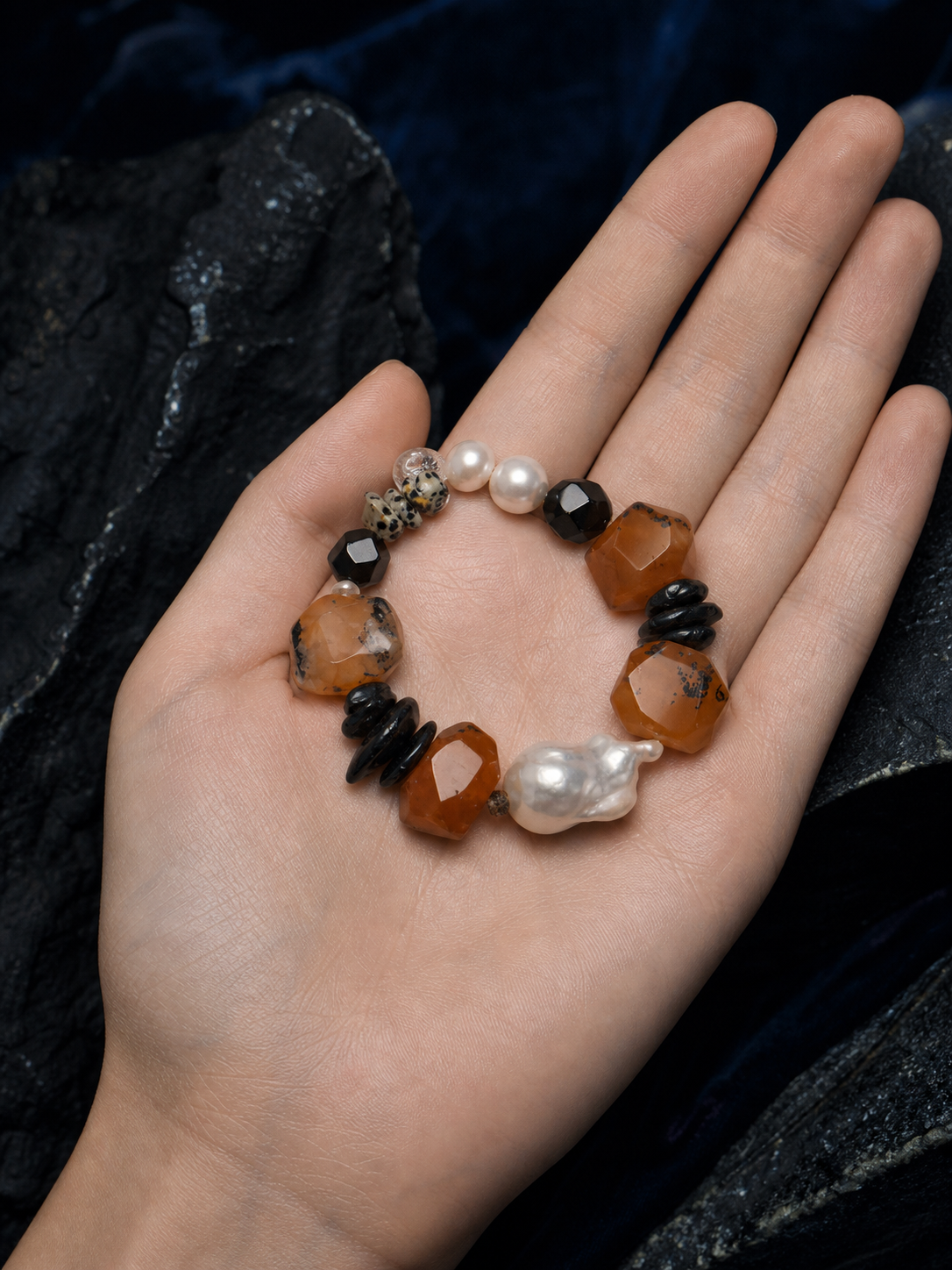 Red Tide Baroque Pearl Bracelet shown in hand for scale