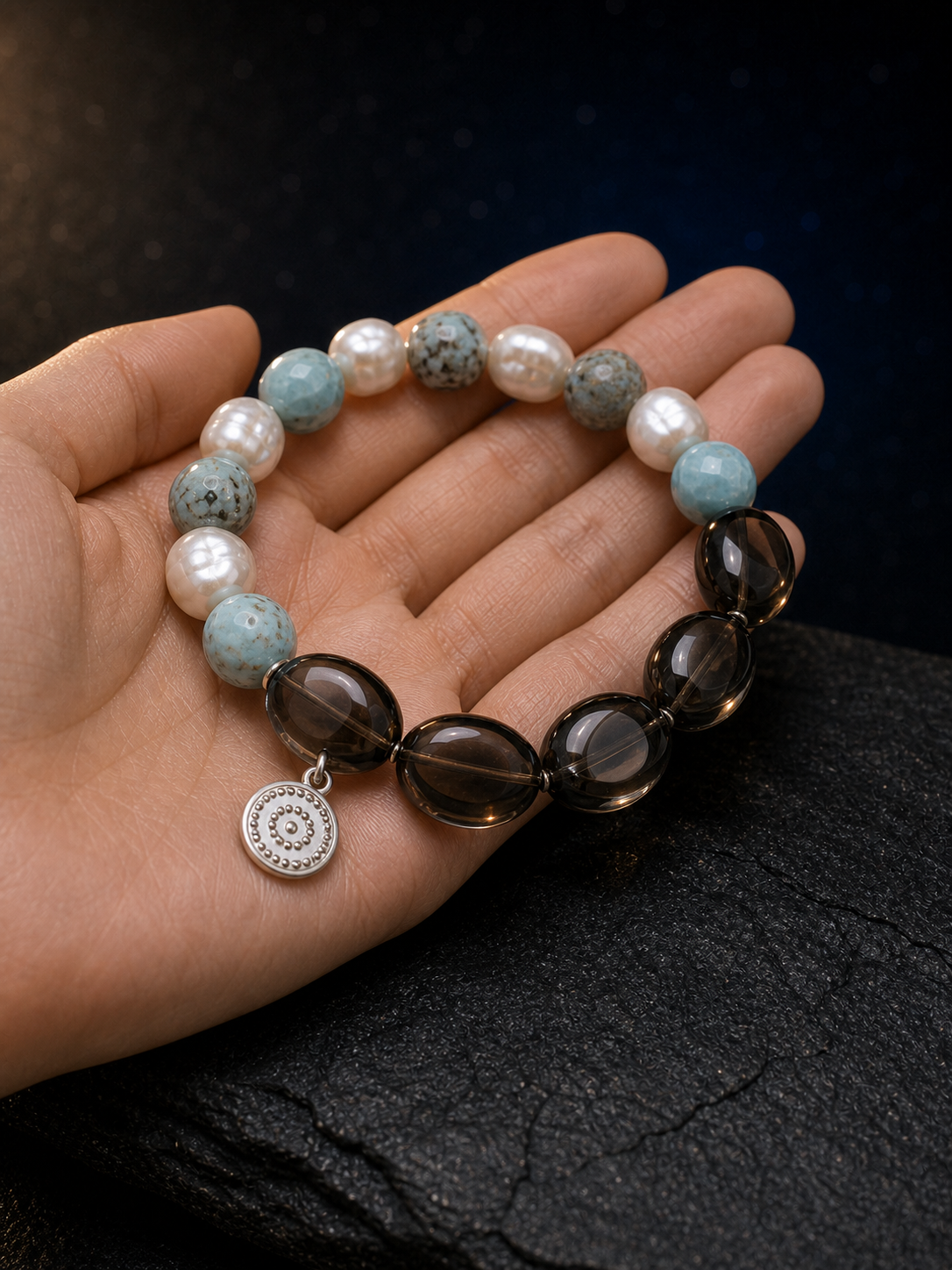 Sea Veil Smoky Pearl Bracelet shown in hand for scale