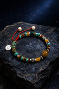 Sunmark Tiger's Eye Turquoise Bracelet front view on a dark atmospheric backdrop