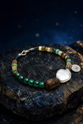 Verdant Lark Malachite Pearl Bracelet front view on a dark atmospheric backdrop